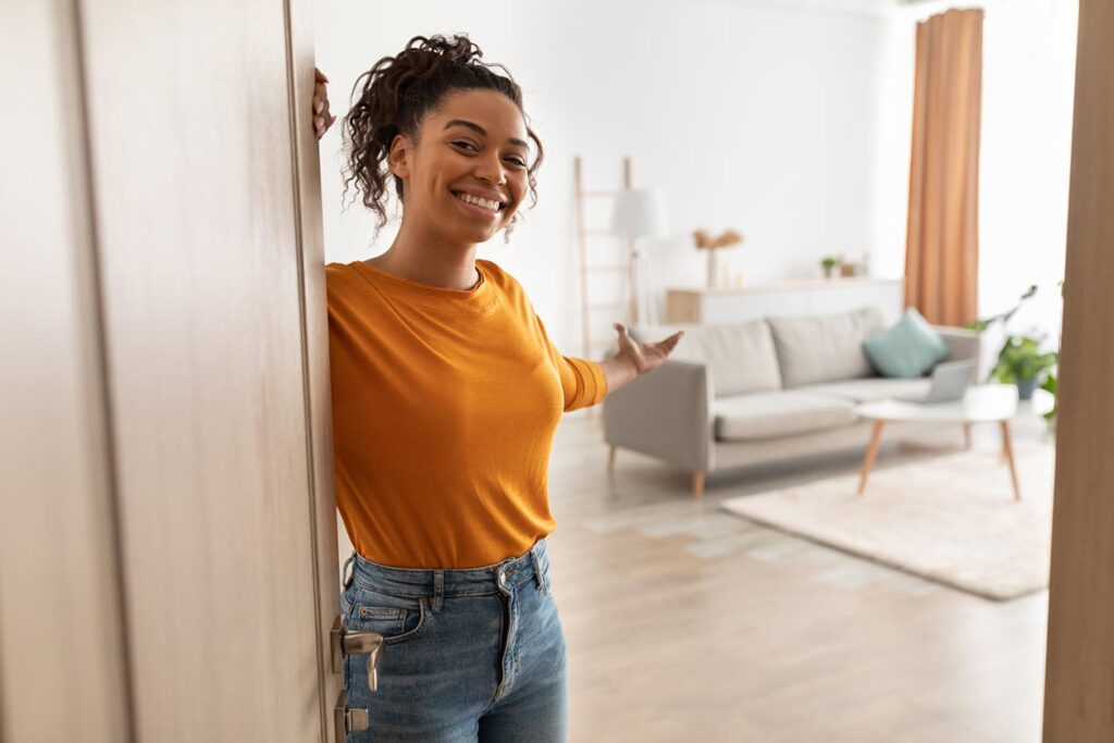 A female opening the door for her Condominium